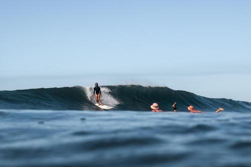 a man riding a wave on a surfboard in the ocean at Hostal Ojo de Agua in Nagarote
