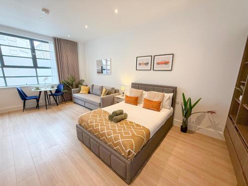 a bedroom with a bed and a living room at 3-Bedroom with Balcony and Studio Apartments in St Johns Wood near Marylebone & Regents Park by Staylio London in London