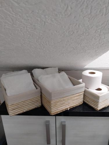 two mattresses and rolls of toilet paper on a shelf at Park Apartment in Kochani