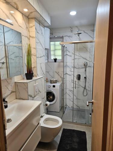 a bathroom with a sink toilet and a shower at Mostar Luxury Apartment in Mostar
