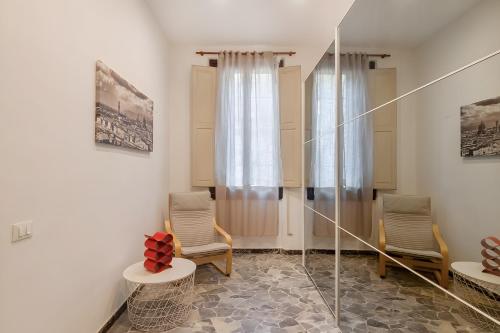a living room with two chairs and a window at La casina di Camilla in Florence