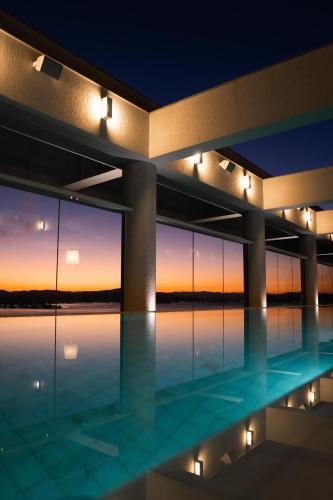 a building with a swimming pool at night at LK Design Hotel Florianópolis in Florianópolis