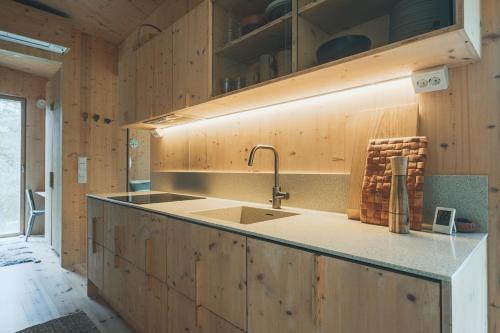 a kitchen with a sink and a counter top at Hideout Villa Jäkälä in Rokua