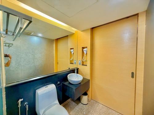 a bathroom with a toilet and a sink at NuEmpire Subang Suite - Empire Hotel in Subang Jaya