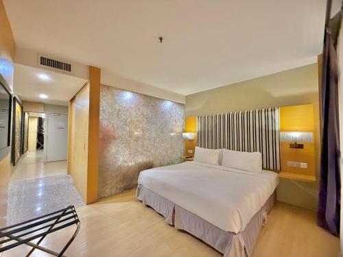 a bedroom with a large white bed in a room at NuEmpire Subang Suite - Empire Hotel in Subang Jaya