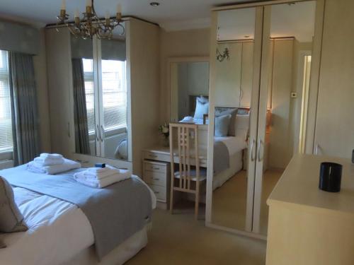 a hotel room with two beds and a mirror at The Flat in Broughton