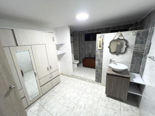 a bathroom with a sink and a shower and a toilet at Como en casa apartment in Cali