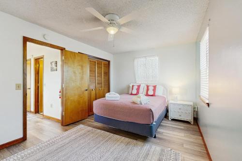 a bedroom with a bed and a ceiling fan at Seascape in Folly Beach