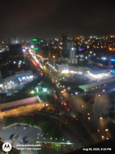 a view of a city at night with lights at Comfort Suites Karachi in Karachi