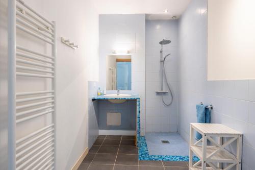a bathroom with a sink and a shower at Le Colombier Gites in Surgères
