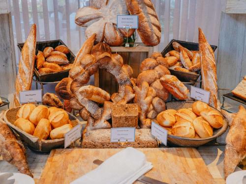 a display of different types of bread and pastries at Sofitel Mauritius L'Imperial Resort & Spa in Flic-en-Flac