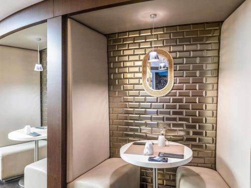 a small bathroom with a mirror and a sink at Mercure Paris Massy Gare TGV in Massy