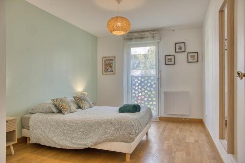 a bedroom with a bed and a window at Le Duplex - Disneyland - Rooftop - Wifi in Montévrain