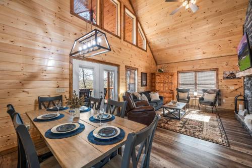 a dining room and living room in a log cabin at Luxury Cabin with Hot Tub and Resort Access in Sevierville