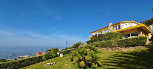 a house on top of a hill next to the ocean at Mega Ocean Magoito - Guest House - Sintra in Sintra