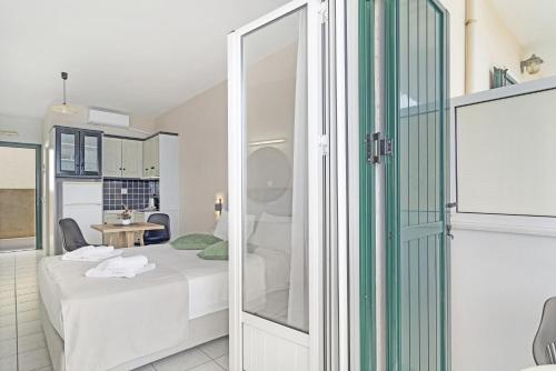 a small room with a bed and a table at Sunset Premium Studio A in Agios Nikitas