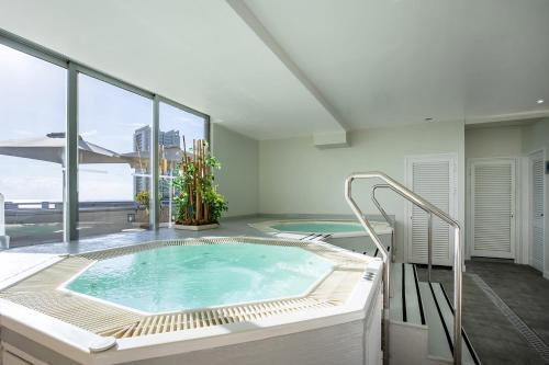 a hot tub in a room with a large window at Eurostars Atlántida in Santa Cruz de Tenerife