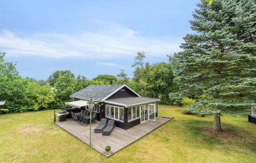 a small house with a deck in a yard at 2 Bedroom Awesome Home In Hasle in Hasle