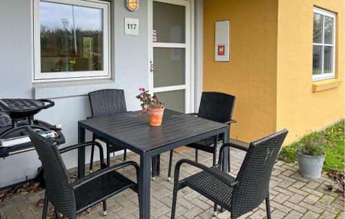 a black table and chairs on a patio with a grill at Awesome Apartment In Hals With House A Panoramic View in Skovsgård