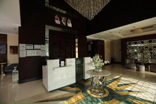 a lobby with a table with flowers on it at Three Points Al Salama in Jeddah