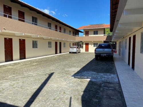 a car parked in a parking lot next to a building at Apartamento acolhedor Maracanaú -Premium in Maracanaú