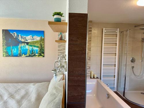 a bathroom with a bath tub and a bathroom with a sink at Tyrolyl - Ferienhaus Tirol in Inzing