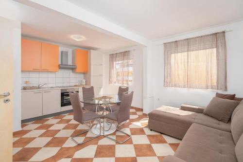 a living room with a couch and a table at Apartments Sanja in Vir
