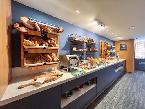 a bakery with lots of different types of bread at Croisette Beach Hotel Cannes - MGallery Collection in Cannes