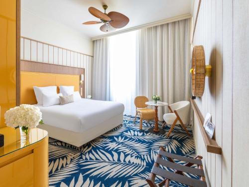 a hotel room with a bed and a table at Grand Hotel Beauvau Marseille Vieux-Port - MGallery Collection in Marseille