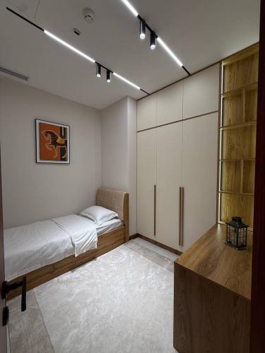 a bedroom with a bed and a closet at Luxury Apartment at Nest One Residence in Tashkent
