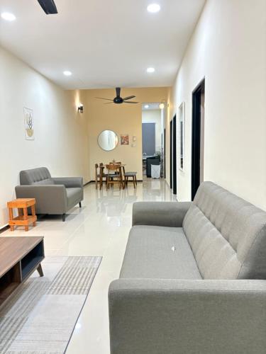 a living room with a couch and a table at Arora Homestay in Marang