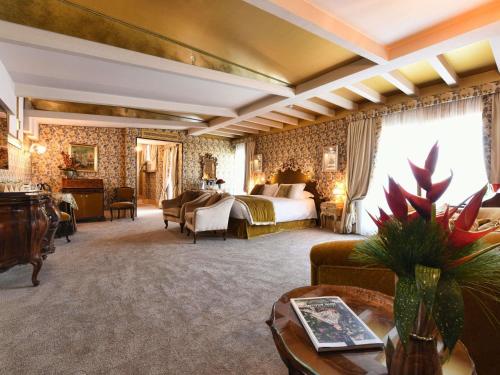 a hotel room with a bed and a couch at Papadopoli Hotel Venezia - MGallery Collection in Venice