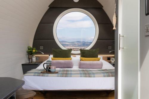 NewburghにあるSeaview Cabin Sleeps 2 -Hot Tub -Smart Tv -Parkingの大きなベッドと大きな窓のある寝室