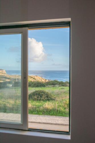 a window with a view of the ocean at Seaview Ensuite rooms in Sagres centre - Casa Maluka in Sagres