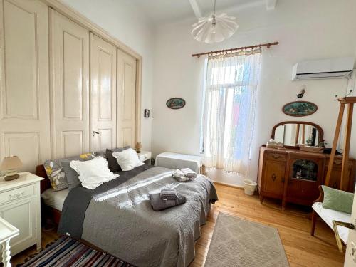 a bedroom with a large bed in a room at Marys Central Beachside Mansion in Agios Nikolaos