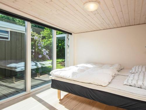 a bedroom with a bed and a sliding glass door at 4 person holiday home in Børkop-By Traum in Børkop