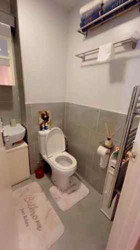 a bathroom with a toilet and a sink at Jay's crash pad in London