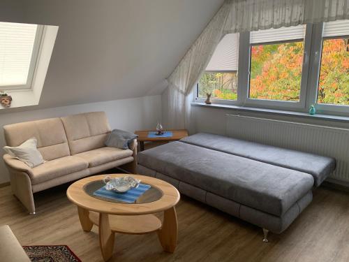 a bedroom with a bed and a couch and a table at 2-Zimmer Ferienwohnung am Teutoburger Wald in Lage