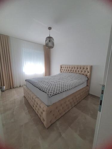 a bedroom with a bed in a room at Apartman City Pearl in Posušje