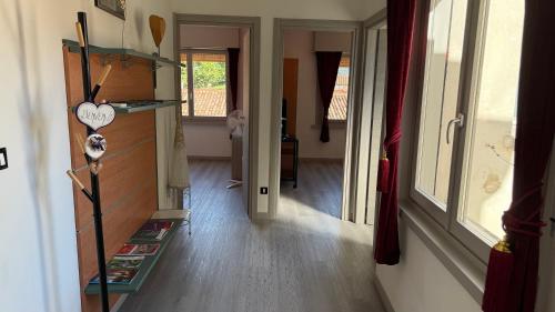 a living room with a book shelf and a hallway at Centro Città 2 in Gorizia