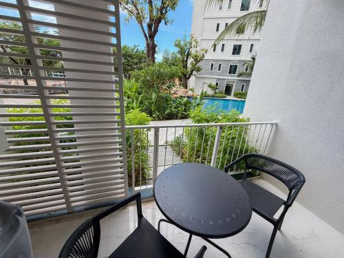 a table and chairs on a balcony with a view at FAMILY HOMES Halo - Brand New 2BDRM Poolside Apartment in Phuket