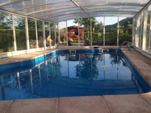 a swimming pool in a house with a glass wall at Villa Margherita in Montaquila