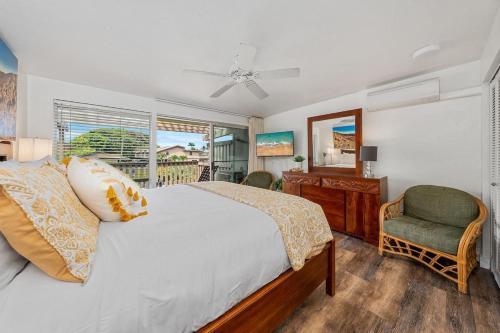 a bedroom with a bed and a desk and a window at Kahana Sunset C1 · KSun C1 Gorgeous Ocean Views Family Vacation in Kahana