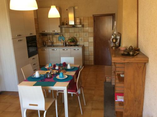 a kitchen with a table and chairs in a kitchen at Villa Giuditta in SantʼAngelo in Pontano