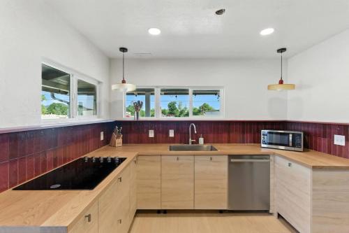 a kitchen with wooden cabinets and a sink at The Cowboy Social Unit 4 in Williams