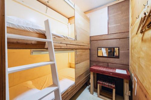 a tiny house with a ladder and a bunk bed at 全室個室のゲストハウス オプンティア Guesthouse Opuntia in Ishigaki Island