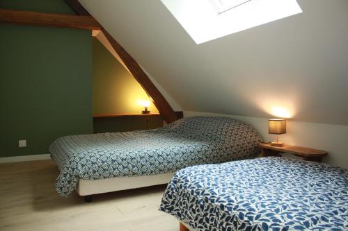 two beds in a room with a attic at Gîte 'Le 31' in Coulaines