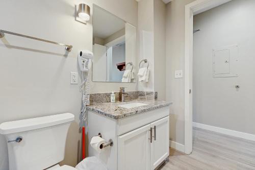a bathroom with a toilet and a sink and a mirror at The Lodge at Stillwater #2012 in Heber City