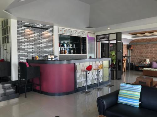 a bar in the middle of a living room at Ingsala by CafeAtLuv22 in Ban Bo Rae