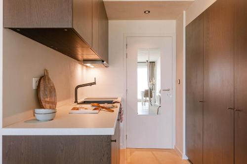 a kitchen with a counter top and a sink at Huswell - Modern studio with magnificent seaview in Koksijde